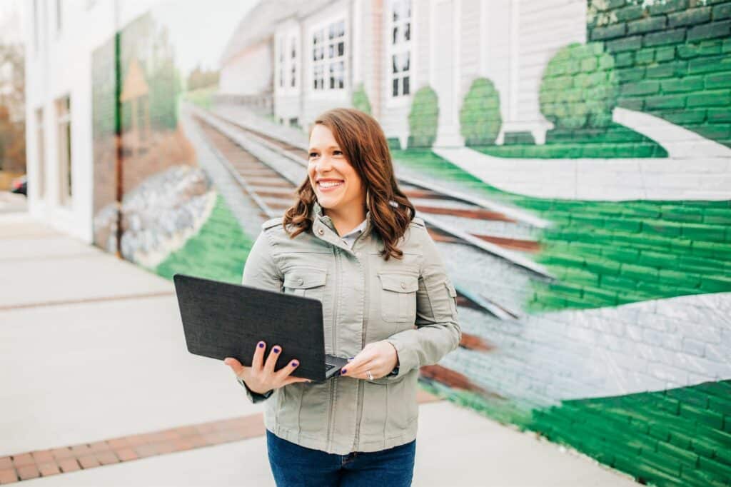 Second Click Media Customer Relationship Management Erin with a laptop